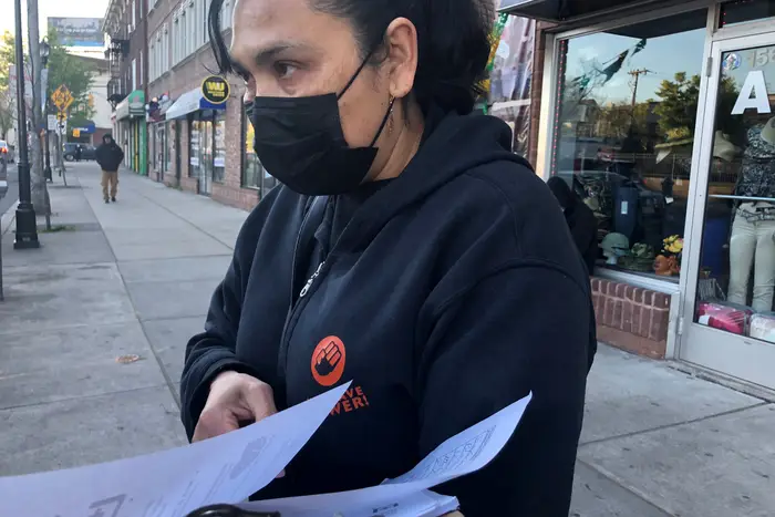 New Labor organizer Reynalda Cruz passes out information on COVID-19 vaccines on New Brunswick’s French Street, April 23rd, 2021. The Visiting Nurses Association sponsored a clinic that week at the organization’s headquarters.